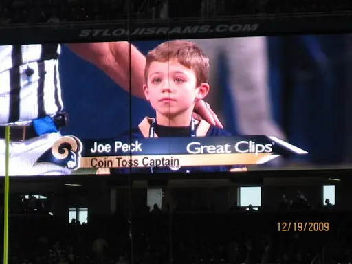 Joe at a football coin toss in 2009 — years before his Chiari diagnosis, already pushing through symptoms nobody could name
